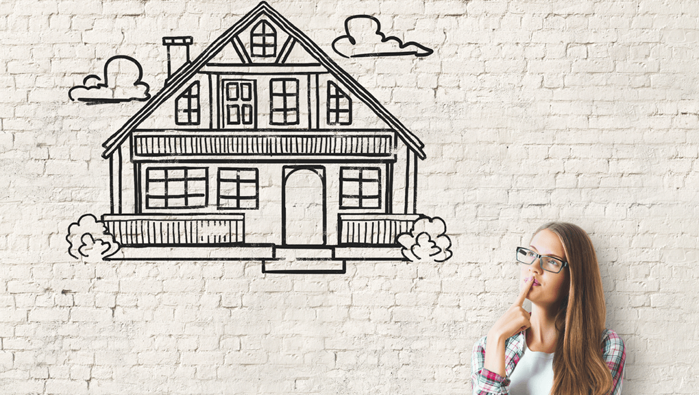 Woman thinking in front of an illustration of a house on a brick wall