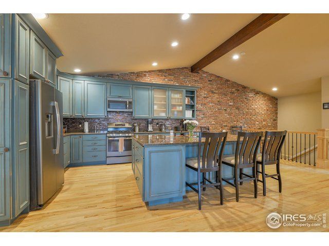 exposed brick kitchen with blue cabinets
