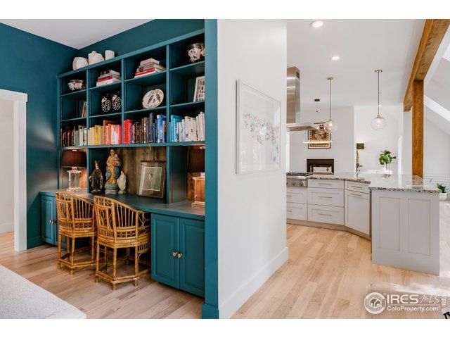 teal blue built ins next to a bright white kitchen