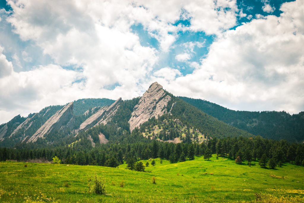Green meadow with Flatiron mountains in background